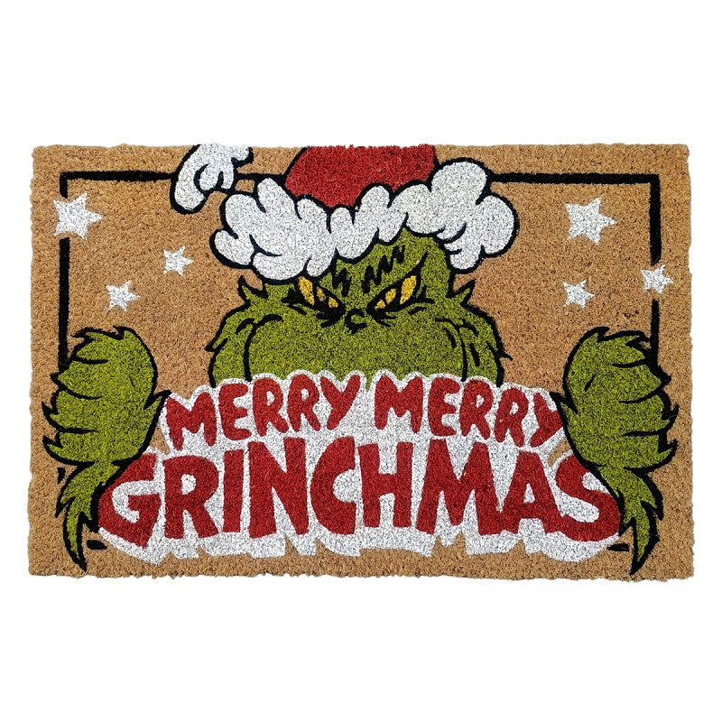 Doormat with Grinch design and 'Merry Grinchmas' text on a brown background